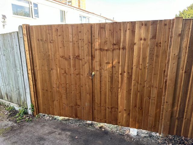A pair of wide closeboard gates across a rear entrance